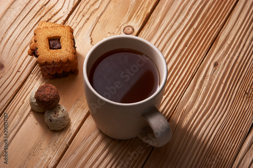 Cup of Tea with Cookies on wooden background photo