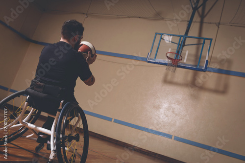 Disabled man practicing basketball in the court  photo
