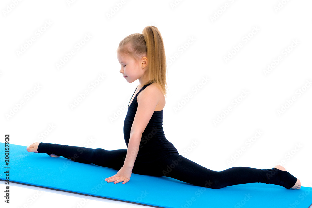 Girl gymnast perform the twine exercise. Girl gymnast perform the twine exercise.