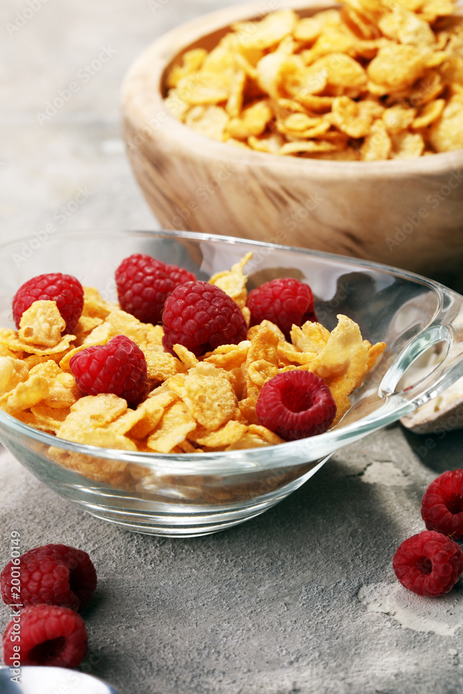 Bowl of Cornflakes and Raspberries for a healthy breakfast concept Bowl of Cornflakes and Raspberries for a healthy breakfast concept