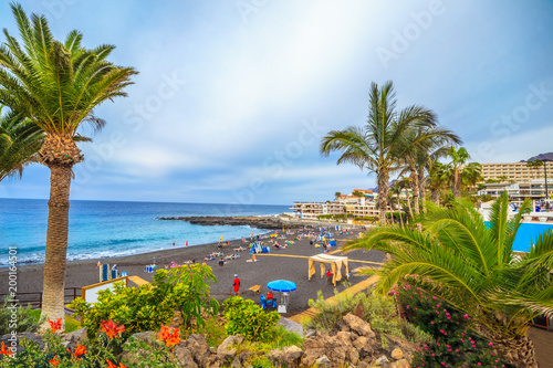People enjoying summer holiday on Arena beach of Tenerife, Canary island of Spain