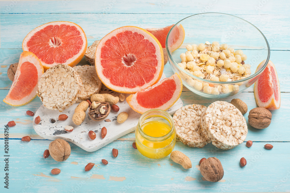 Grapefruit, muesli and bread. View from above, with an empty place for the inscription. The concept of a diet Grapefruit, muesli and bread. View from above, with an empty place for the inscription. The concept of a diet