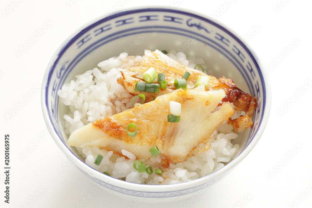 Chinese food, pan fried flat fish and spring onion on white rice Chinese food, pan fried flat fish and spring onion on white rice