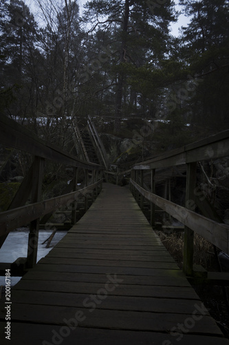 Bridge over a lake and stairway up a mountain, to a forest. Nackareservatet - nature reserve in Sweden