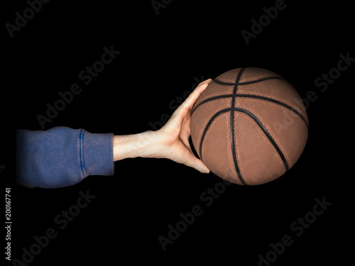 hand palming basketball close up in dark studio © Mihail