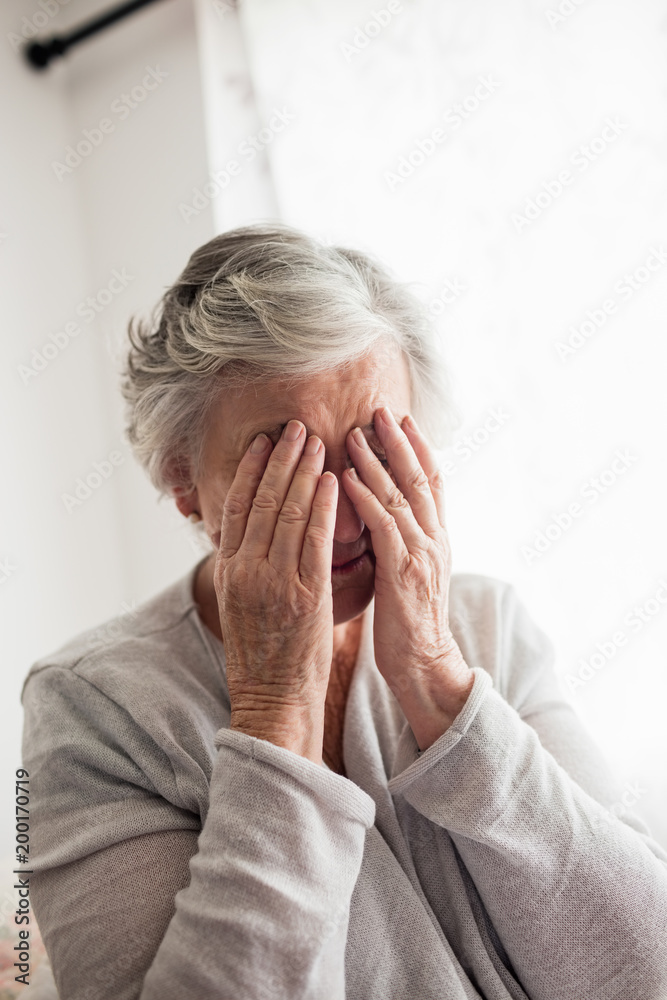 Senior woman covering eyes with her hands Senior woman covering eyes with her hands