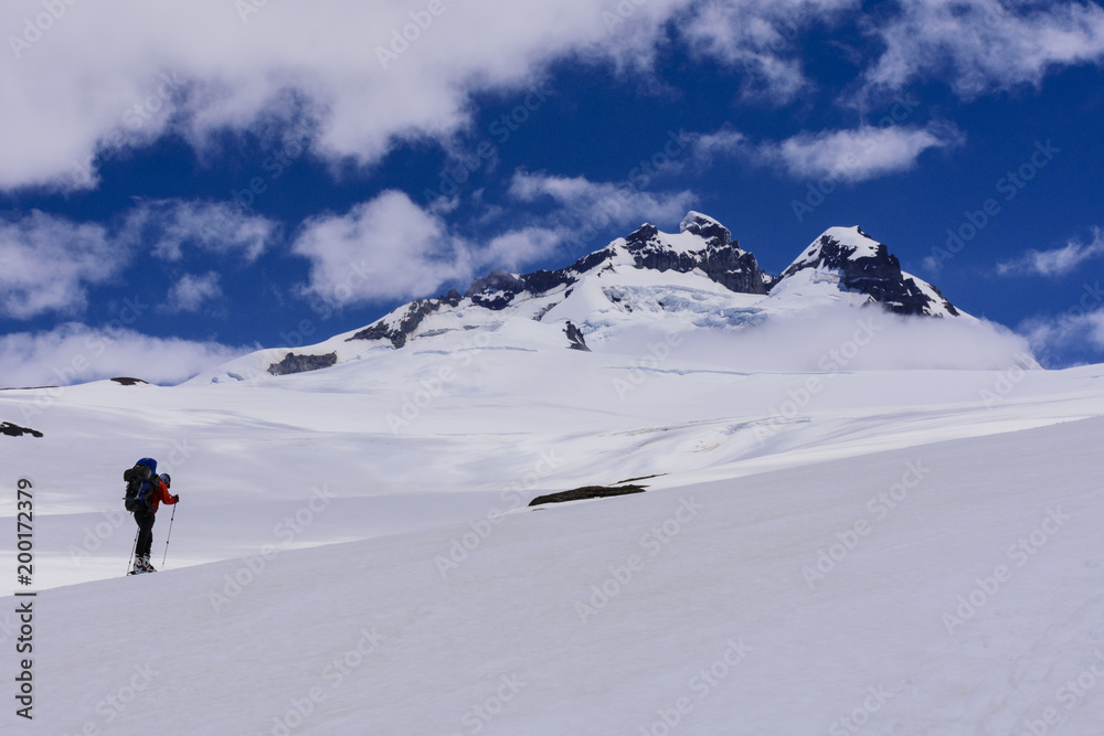 Scene view of mountain skier against Mount Tronador in Pampa Linda, Nahuel Huapi National Park, Bariloche, Patagonia, Argentina