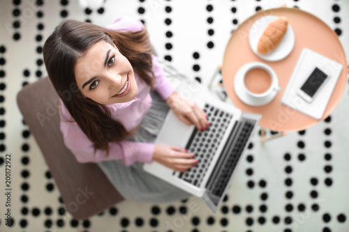 Beautiful young woman using...