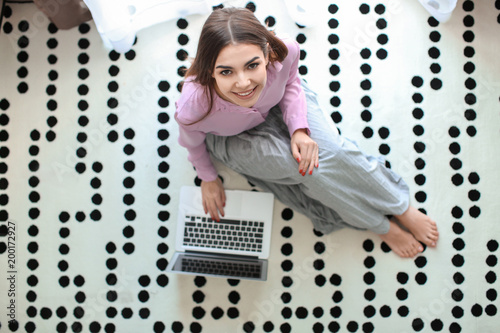 Beautiful young woman using...