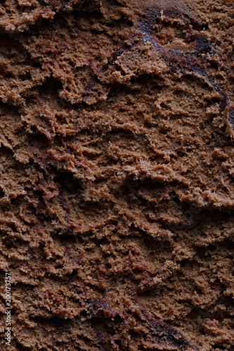 Surface of chocolate ice cream, sweet frozen dessert for summer breakfast. Photographed close-up.