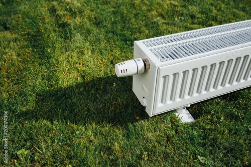 Bilde på lerret radiator on green lawn, ecological heating concept