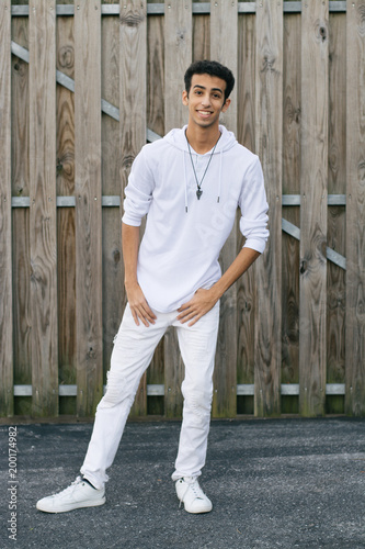 Young Male Model Having Fun in Front of Wooden Wall © MeganMahoneyPhotos