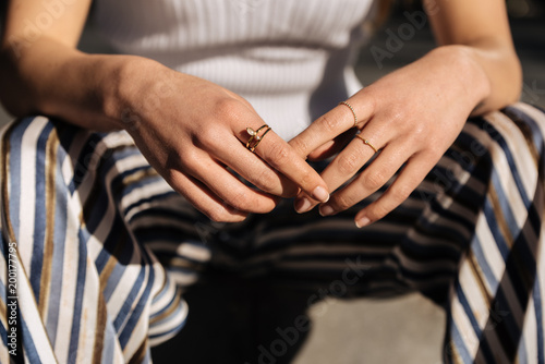 Crop woman hands with rings on the street