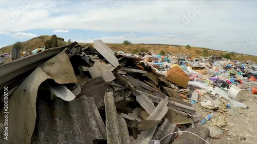 the camera moves away from the dump. Slow motion.