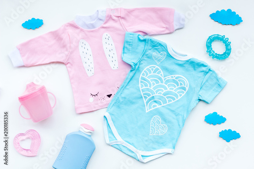 Baby shower concept. Baby's clothes and accessories on light background top view