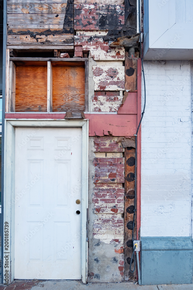 Aging window and door in a brick building in downtown Anniston, Alabama, USA