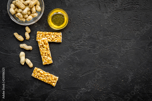 Energy protein snacks with peanuts on black background top view copy space