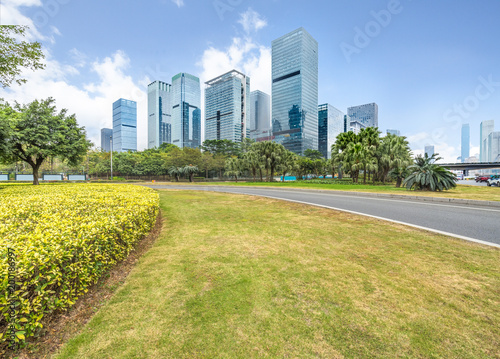 cityscape and skyline of shenzhen from meadow in park