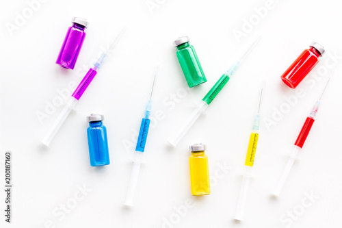 Medical injection. Syringe, bottle with remedy on white background top view