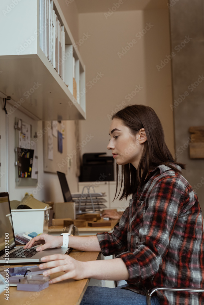 Female executive working on laptop at desk Female executive working on laptop at desk