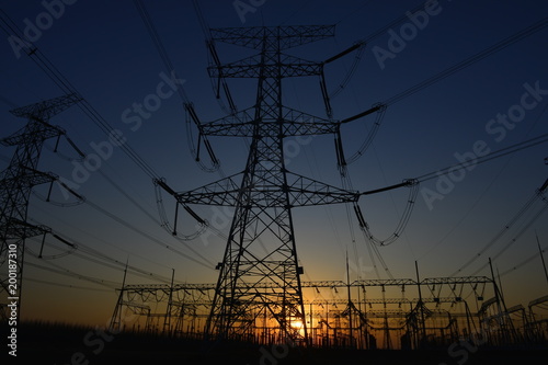 The silhouette of the evening electricity transmission pylon