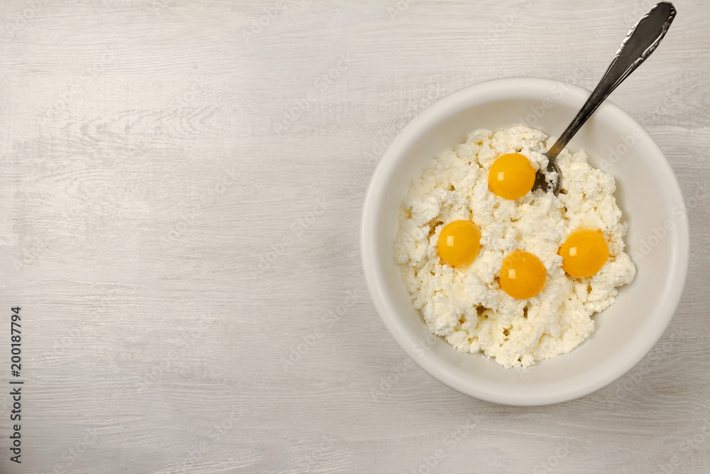 White bowl with ingredients for cheese cake. White bowl with ingredients for cheese cake.