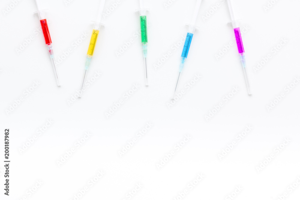 Syringe with colored drug. Injection concept on white background top view copy space Syringe with colored drug. Injection concept on white background top view copy space
