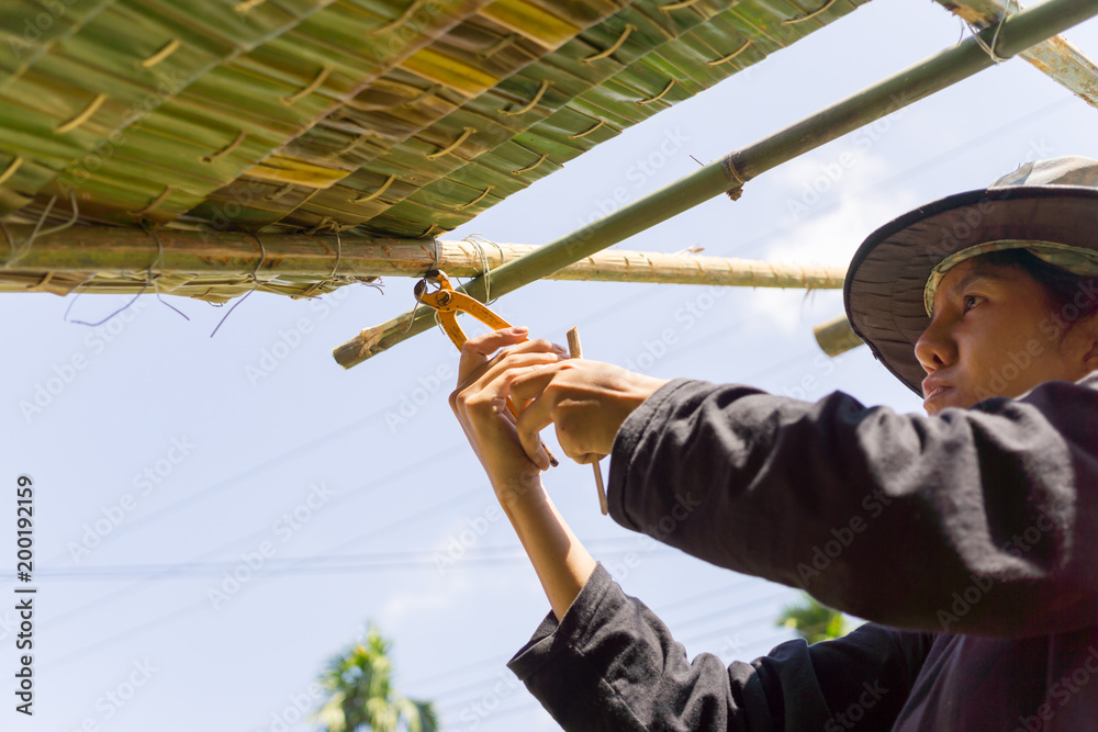 Naklejka premium female worker is thatching roof, concept about labor