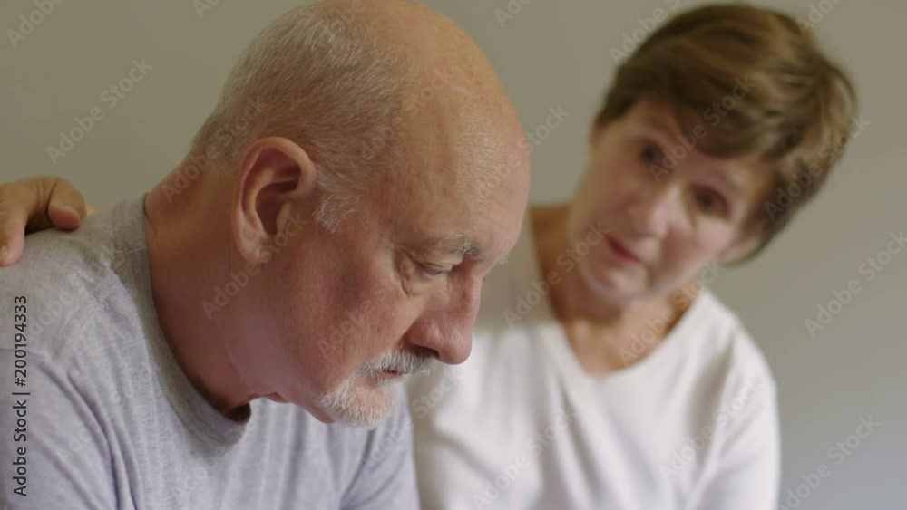 Older woman consoling older man