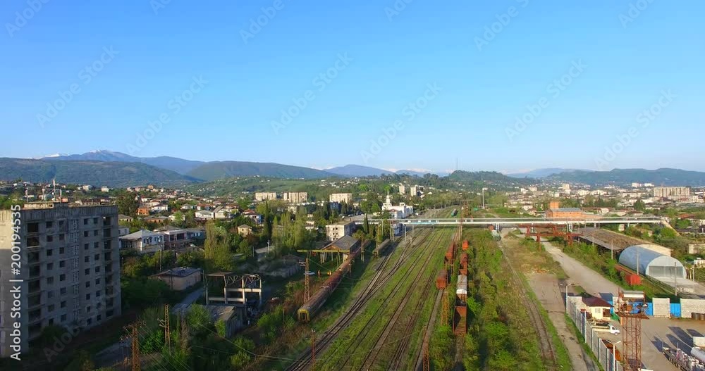 Top view of the cityscape with the railroad under the blue sky. Top view of the cityscape with the railroad under the blue sky.