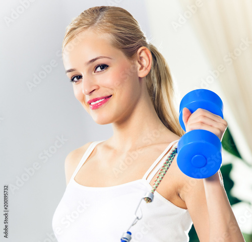 Woman exercising with dumbbells and growth