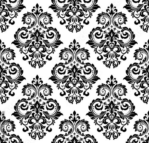 Wallpaper in the style of Baroque. A seamless vector background. White and black floral ornament. Graphic vector pattern