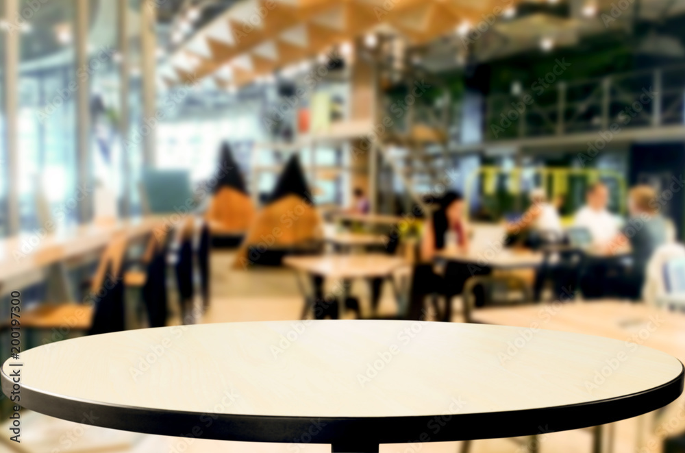 Selected focus empty brown wooden table and Coffee shop or restaurant blur background with bokeh image. for your photomontage or product display.