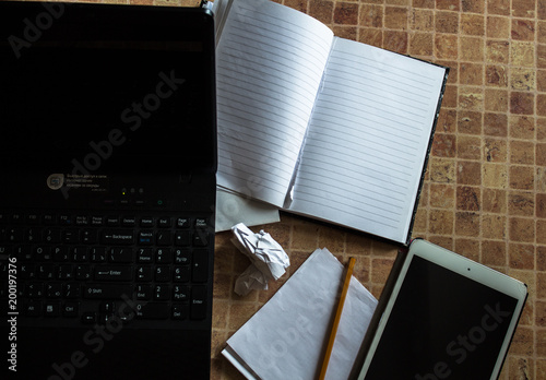 laptop tablet and notebook with pencil on the table