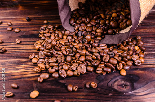 Roasted coffee beans in sack on wooden table © ihorbondarenko
