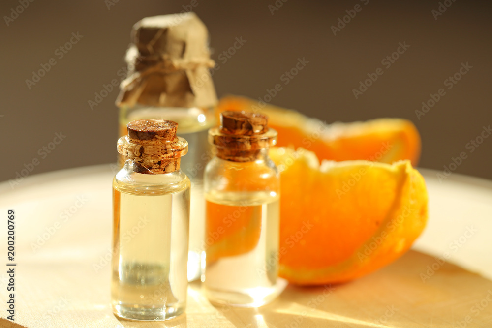 orange oil .essential citrus oil. set of essential orange oil and fresh orange on a wooden board on a blurry background. Pure natural organic essential oil orange oil .essential citrus oil. set of essential orange oil and fresh orange on a wooden board on a blurry background. Pure natural organic essential oil