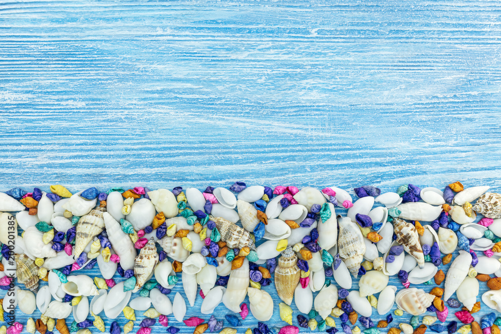 multicolored seashells on blue wooden shabby background. summer holiday background multicolored seashells on blue wooden shabby background. summer holiday background