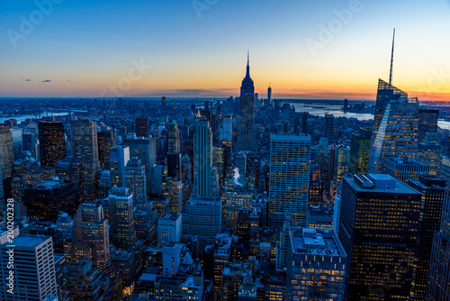 New York City skyline at night - skyscrapers of midtown Manhattan with Empire State Building at Amazing Sunset - USA