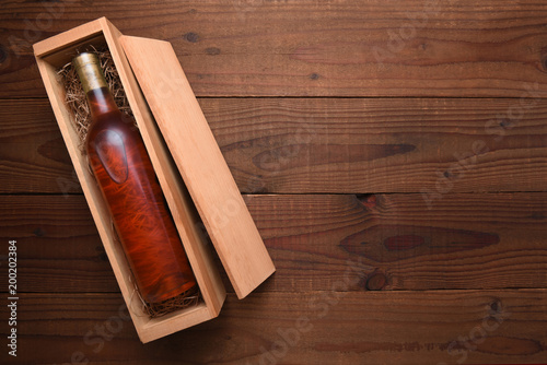 A single Bottle of Blush wine in its wooden case