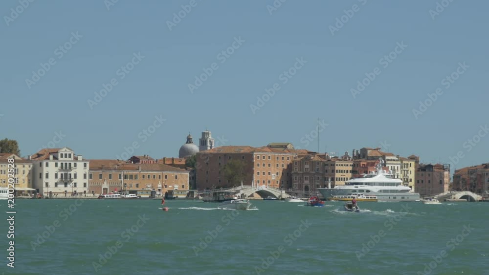 Laguna Veneta with boats, buildings and a bridge Laguna Veneta with boats, buildings and a bridge