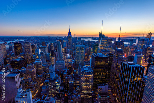 New York City skyline at night - skyscrapers of midtown Manhattan with Empire State Building at Amazing Sunset - USA
