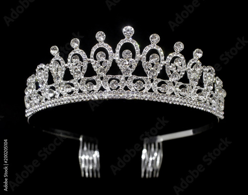 Silver tiara diadem with gems and diamonds isolated on black background