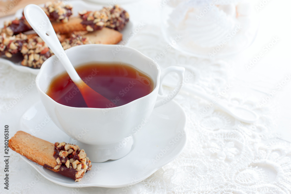 Cookies with nuts and chocolate and a cup of tea, horizontal