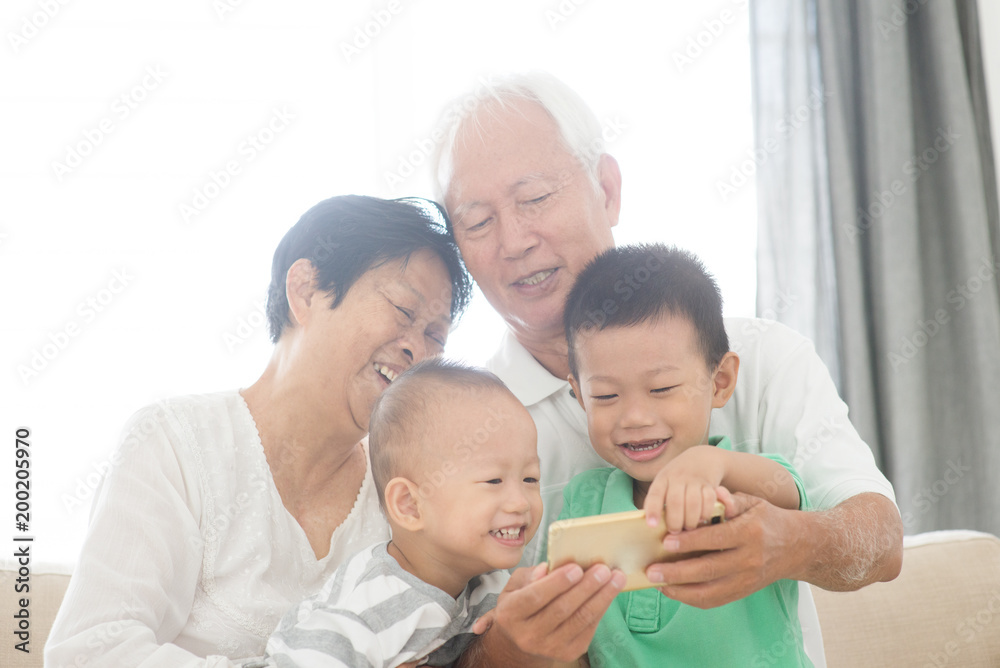 Grandparents and grandchildren taking selfie using smart phones Grandparents and grandchildren taking selfie using smart phones