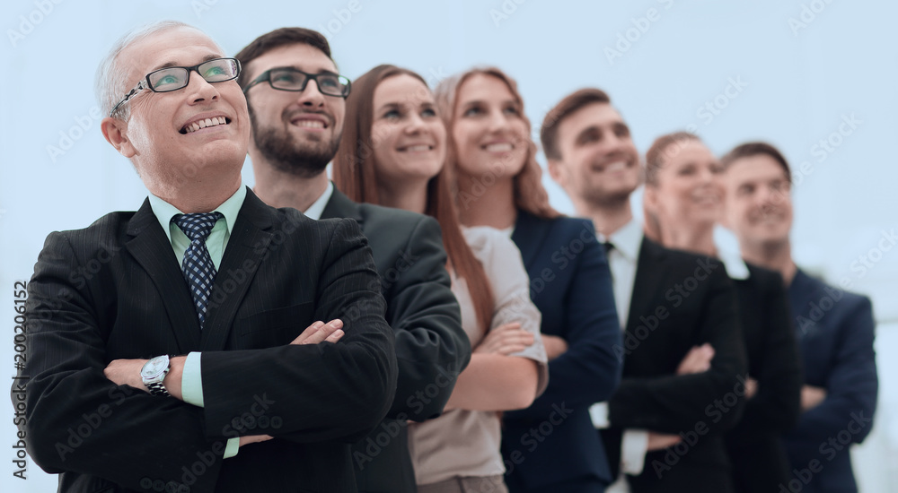 senior businessman and his team are confident looking ahead. senior businessman and his team are confident looking ahead.