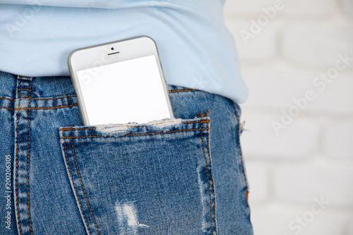 Smartphone with blank screen in jeans pocket.