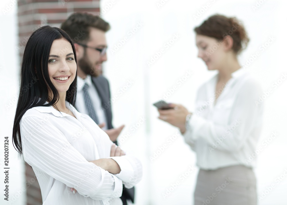 close-up of a beautiful woman manager and co-workers in the office close-up of a beautiful woman manager and co-workers in the office