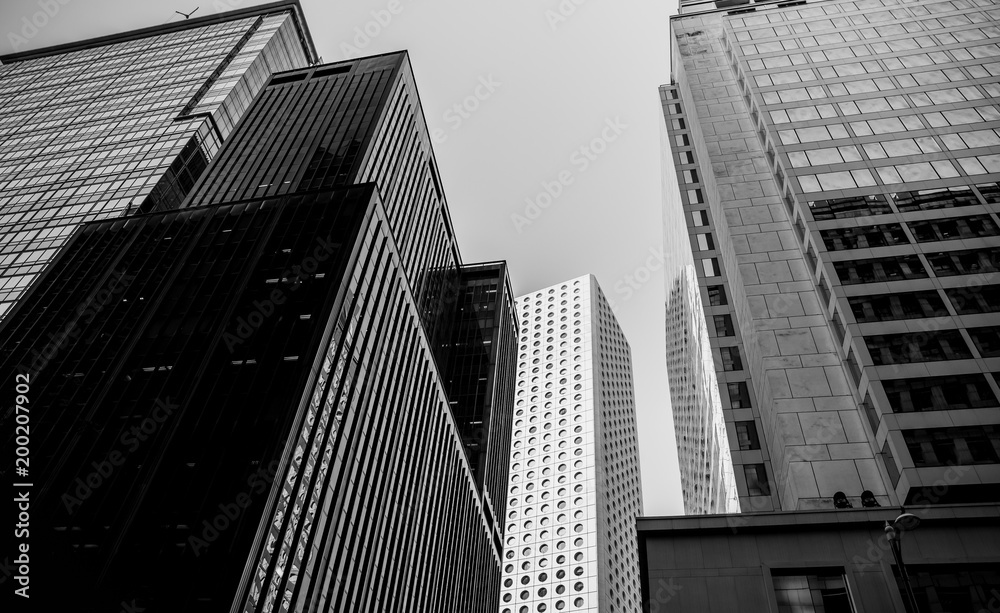 Fototapeta premium Bottom up view of Modern office building in Hong Kong with B&W color