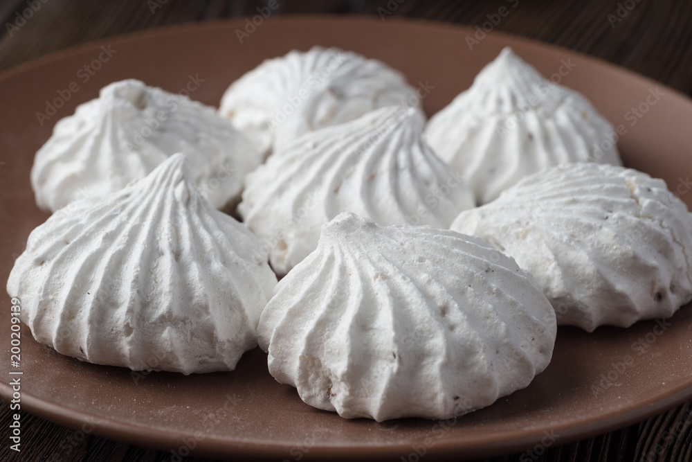 White zephyr marshmallow on porcelain plate White zephyr marshmallow on porcelain plate