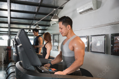 Healthy man start a treadmill together